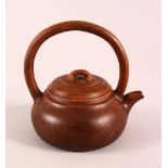 A CHINESE YIXING CLAY TEAPOT, with a fixed moulded handle, the base with a da bin mark, 16cm high.