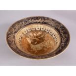 AN EARLY ISLAMIC POSSIBLY PERSIAN GLAZED POTTERY BOWL, with central decoration of a deer, and rim