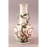 A CHINESE FAMILLE ROSE TWIN HANDLE PORCELAIN VASE, decorated to the body with native flora and