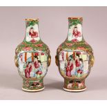 A PAIR OF 19TH CENTURY CHINESE CANTON FAMILLE ROSE PORCELAIN VASES, with panelled figural decoration