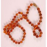 AN AMBER BEAD NECKLACE, 74cm long, each bead approx. 8-10mm, weight 30g.