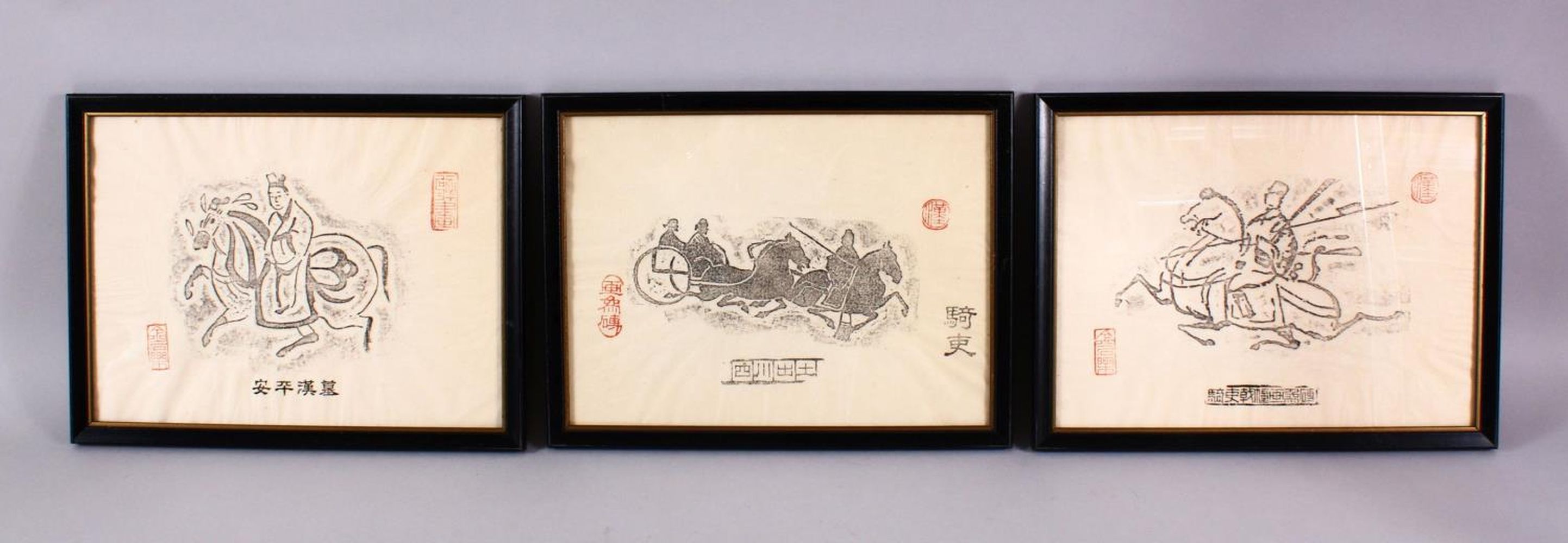 THREE FRAMED CHINESE TEMPLE RUBBINGS, each with a different view of a figure upon horses, each