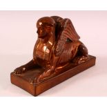 AN UNUSUAL COPPER LUSTRE DECORATED POTTERY MODEL OF SPHINX, impressed mark to base Wedgwood, 17cm