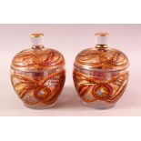 A PAIR OF BOHEMIAN RED ENAMELLED GLASS JARS, each with enamel and gilt work, 20cm each
