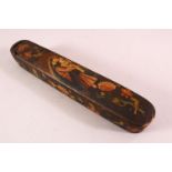 A PERSIAN QAJAR LACQUERED PEN BOX containing the brass inkwell, 23cm long.