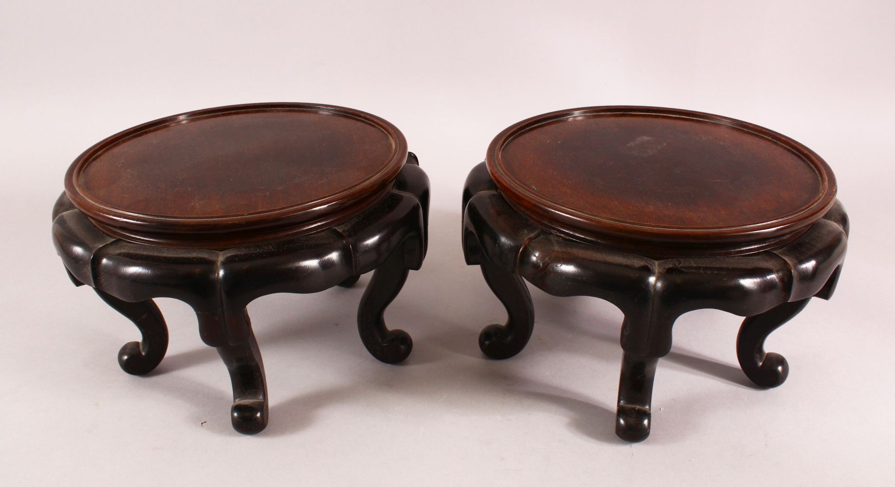 A PAIR OF 19TH CENTURY CHINESE CARVED HARDWOOD STANDS. each with five curving feet, 26cm wide