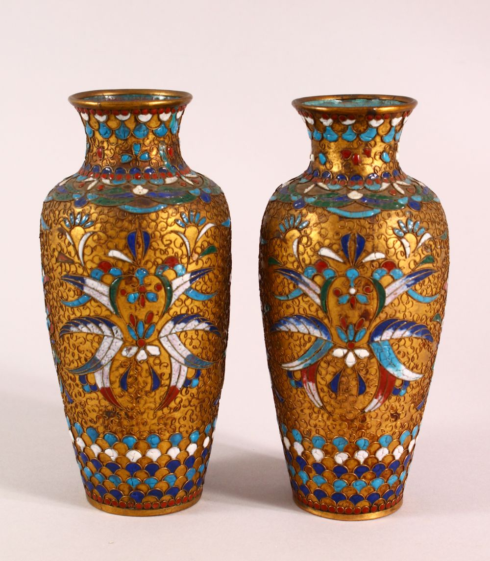 A SMALL PAIR OF CLOISONNE AND RAISED WIRE VASES, 16cm high.