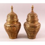 A PAIR OF QAJAR OPENWORK BRASS VASES & COVERS, with roundel figural decoration, 28cm