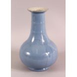 A CHINESE SKY BLUE CRACKLE GLAZED PORCELAIN VASE, 23cm.