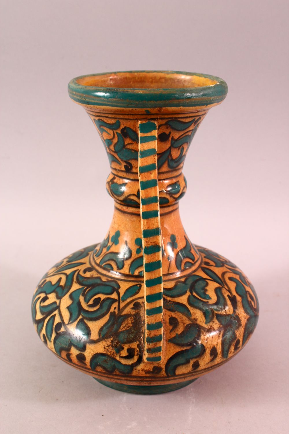 A MOROCCAN POTTERY FLORAL VASE - SIGNED BY BIN JALAL, with twin handles and green foliage - Image 6 of 8