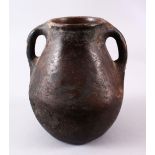 A 10TH CENTURY IRANIAN POTTERY TWIN HANDLE JUG, 22cm high.