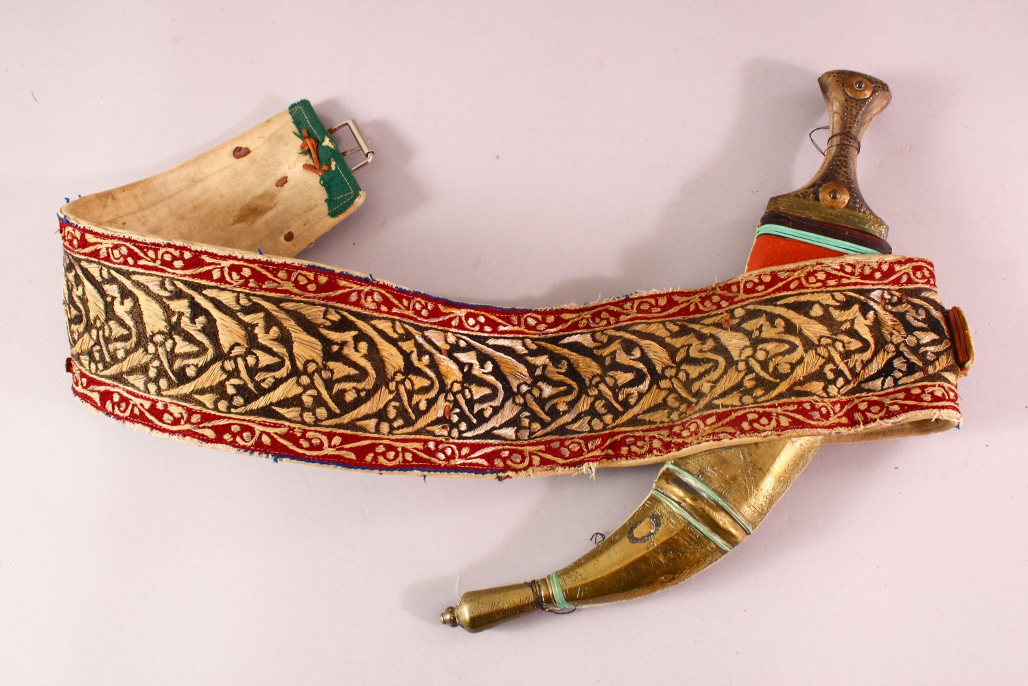 A YEMINI JAMBIYA DAGGER with original belt.