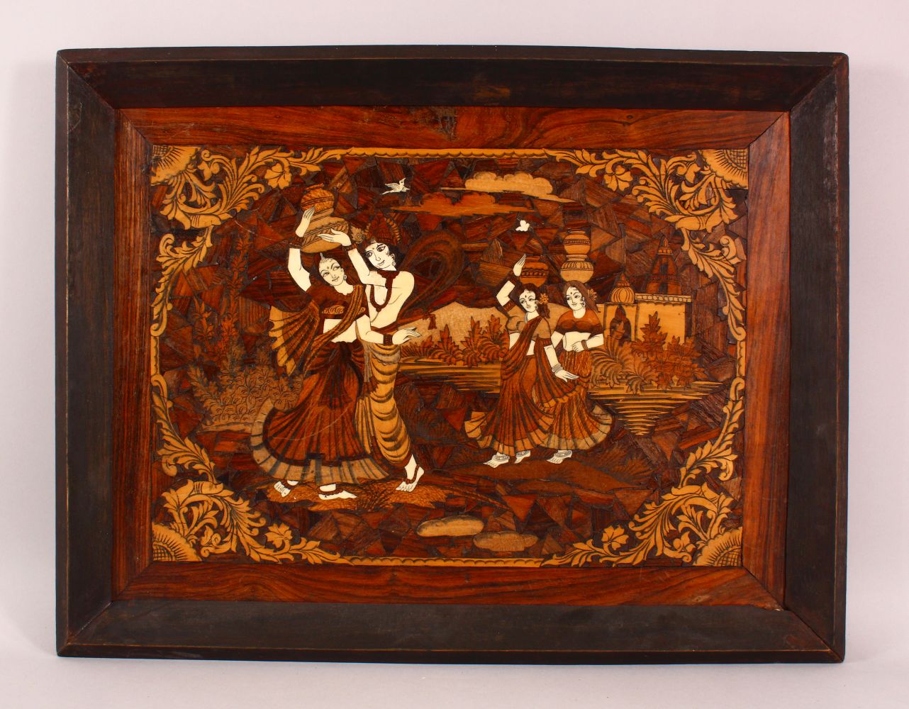 AN INDIAN INLAID WOODEN PANEL, inlaid with exotic woods and bone, depicting figures, 67cm x 52cm.