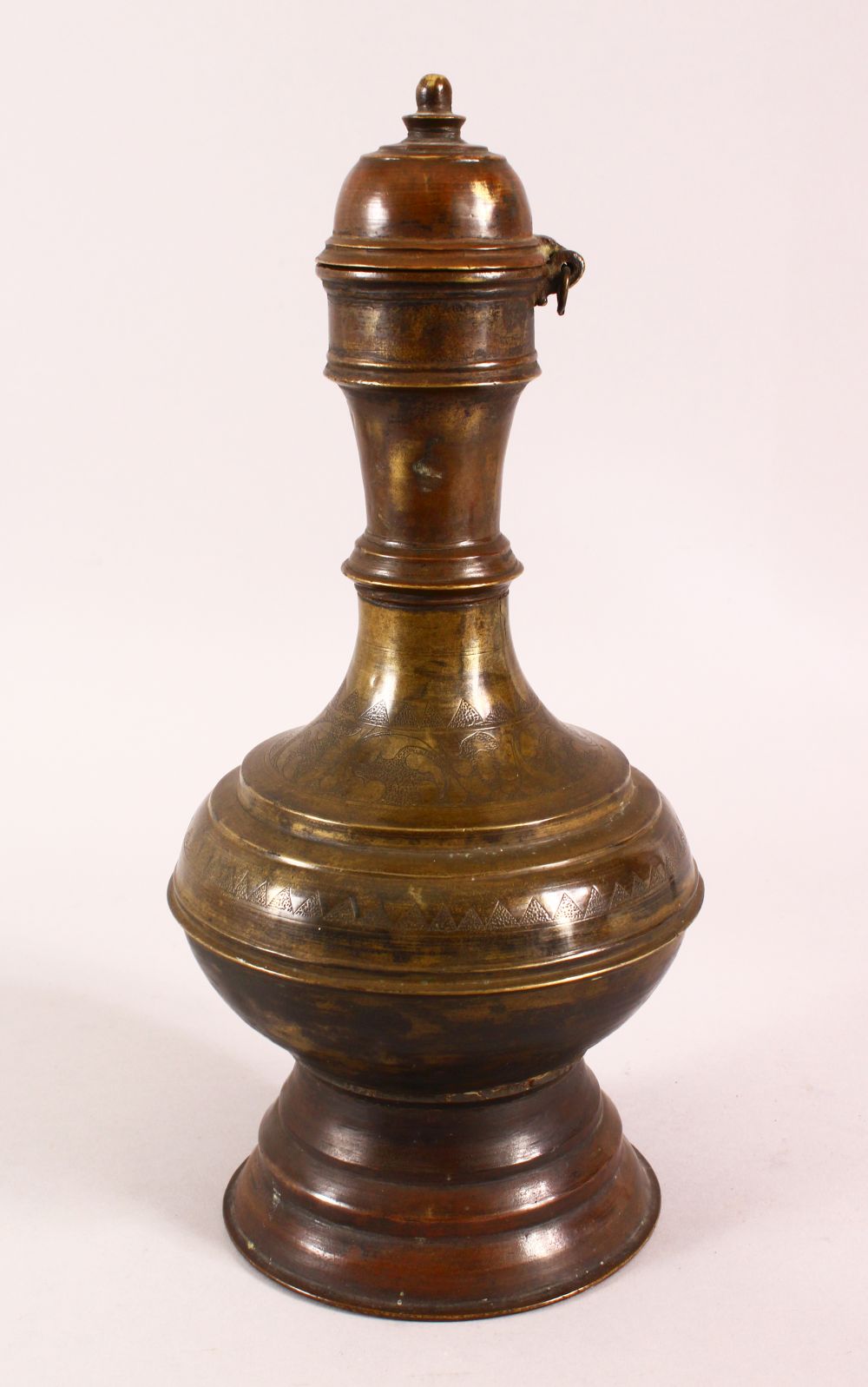 A 19TH CENTURY INDIAN BRONZE EWER, with chased floral decoration, 34cm