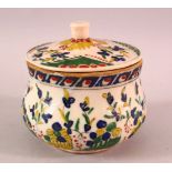 A TURKISH OTTOMAN KUTAHYA POTTERY JAR & COVER, decorated with flora 11cm high.