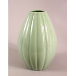 A CHINESE CELADON GLAZED RIBBED PORCELAIN VASE, the base with a six character mark, 24cm high,
