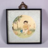 A SMALL CHINESE FRAMED PAINTING ON SILK - the cut out section depicting a young girl seated in a