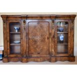 A GOOD VICTORIAN FIGURED WALNUT CREDENZA, the front with central panel drawer, flanked by glass