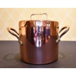 A COPPER TWO-HANDLED POT AND COVER.