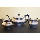 A SEMI FLUTED SILVER THREE PIECE TEA SET, comprising teapot, sugar basin and milk jug.London 1995.