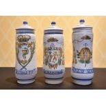 A SET OF THREE SPANISH POTTERY DRUG JARS AND COVERS.