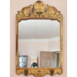 A GEORGE I GILT GESSO MIRROR. 3ft 3ins long x 2ft wide. Missing candle sconces.
