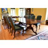 A GOOD MAHOGANY DOUBLE PILLAR DINING TABLE with loose leaf, on two pillars with tripod curving