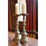 A PAIR OF TURNED WOOD CANDLESTICKS, possibly Italian.1ft 6ins high.