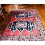 A PERSIAN WOOL RUG with two main medallions within a three-row border. 7ft x 4ft 8ins.