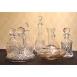A CUT GLASS SHIPS DECANTER AND STOPPER AND SIX OTHER DECANTERS.
