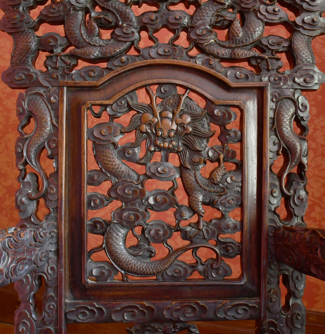 A GOOD PAIR OF CHINESE CARVED AND PIERCED ARMCHAIRS with solid seats, dragon arms and foliage. - Image 2 of 3