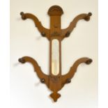A VICTORIAN MAHOGANY TWO ARM HAT STAND with mirrored back.
