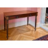 A LATE REGENCY MAHOGANY PLAIN SIDE TABLE with frieze drawer, on fluted turned legs. 3ft 6ins long.