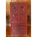 A GOOD CHINESE CARVED RED LACQUER STANDING CABINET, with double panel doors enclosing eight drawers,