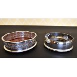 A CIRCULAR SILVER WINE COASTER and A PIERCED PLATED WINE COASTER (2).