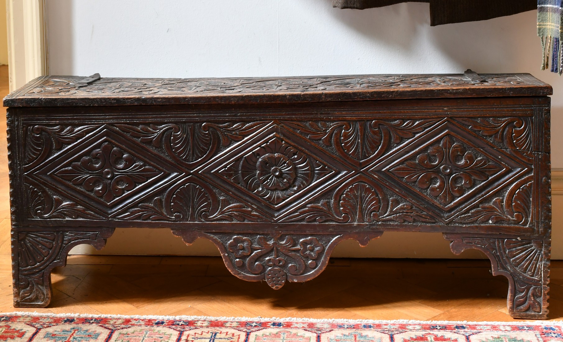 A 17TH CENTURY CARVED OAK SWORD CHEST. 3ft 9ins long x 1ft wide.