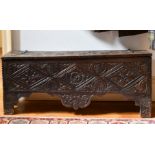 A 17TH CENTURY CARVED OAK SWORD CHEST. 3ft 9ins long x 1ft wide.