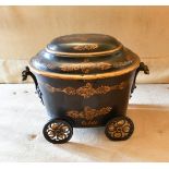 A VICTORIAN OVAL PONTYPOOL COAL BOX AND COVER on four wheels. 1ft 8ins.