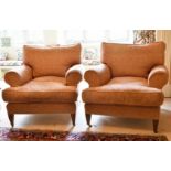 A GOOD PAIR OF LARGE DEEP EASY ARMCHAIRS on tapering legs with brass castors.