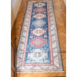 A SMALL PERSIAN RUNNER RUG with seven medallions. 8ft x 2ft 8ins.