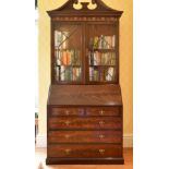 A GEORGE III DESIGN MAHOGANY BUREAU BOOKCASE, the top with swan neck pediment over glazed astragal