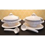 A LARGE PAIR OF ITALIAN WHITE POTTERY TUREENS, COVERS AND STANDS.