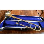 A BLESSING SCHOLASTIC BRASS TROMBONE, in a case.