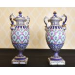 A PAIR OF SEVRES PORCELAIN TWO-HANDLED VASES AND COVERS sprigged with roses.Mark in blue. 12ins