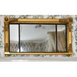 A LATE REGENCY GILTWOOD OVERMANTLE MIRROR with three mirrored panels. 4ft long x 2ft high.