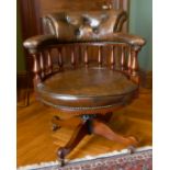 A GOOD MAHOGANY AND LEATHER TUB SWIVEL OFFICE CHAIR with buttoned back.