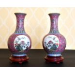 A PAIR OF CHINESE FAMILLE ROSE BULBOUS VASES with circular panels of birds and flowers. 9ins high,