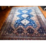 A GOOD PERSIAN RUG with three central diamond medallions. 7ft 9ins x 5ft 9ins.