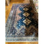 A GOOD PERSIAN RUG with three diamond shaped medallions. 7ft 9ins x 5ft 2ins.
