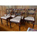 A SET OF SIX VICTORIAN ROSEWOOD SINGLE CHAIRS with shaped backs, drop-in seats, on turned legs.
